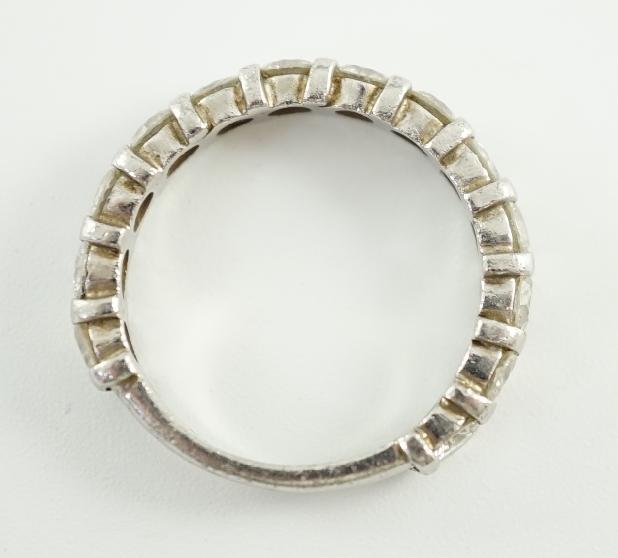 An 18ct white gold and thirteen stone round brilliant cut diamond set three quarter eternity ring